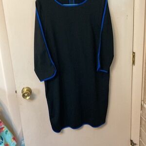 Black knit dress with back zipper and royal blue trim.